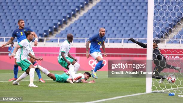 Ali Alhassan of Team Saudi Arabia scores their side's first goal past Santos of Team Brazil during the Men's First Round Group D match between Saudi...