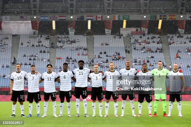 Players of Team Germany stand for the national anthem prior to the Men's Group D match between Germany and Cote d'Ivoire on day five of the Tokyo...