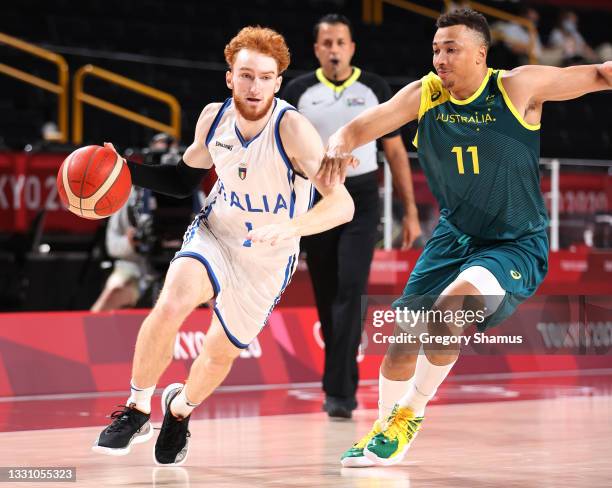 Niccolo Mannion of Team Italy drives to the basket against Dante Exum of Team Australia during the first half of a Men's Preliminary Round Group B...