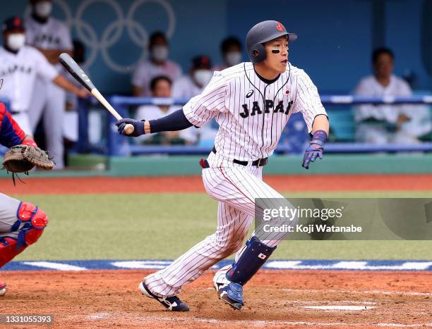 Yuki Yanagita of Team Japan hits an infield single to first base against Team Dominican Republic in the ninth inning during the baseball opening...