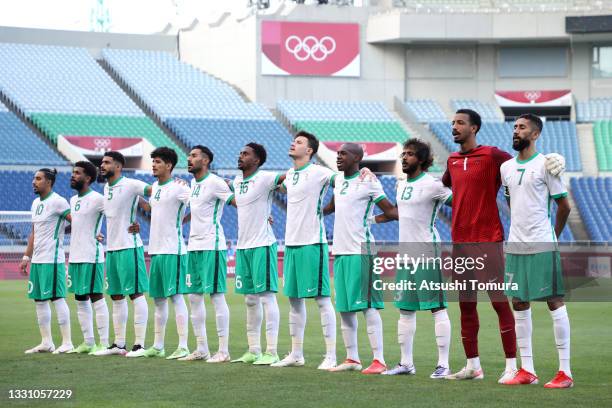 Players of Team Saudi Arabia stand for the national anthem prior to the Men's First Round Group D match between Saudi Arabia and Brazil on day five...