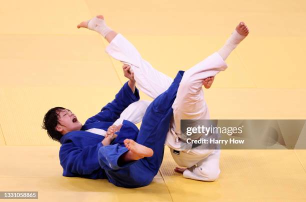 Chizuru Arai of Team Japan and Madina Taimazova of Russian Olympic Committee compete during the Women’s 70kg Semifinal of Table B on day five of the...