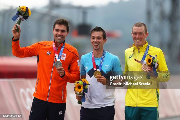 Silver medalist Tom Dumoulin of Team Netherlands, gold medalist Primoz Roglic of Team Slovenia, and bronze medalist Rohan Dennis of Team Australia,...