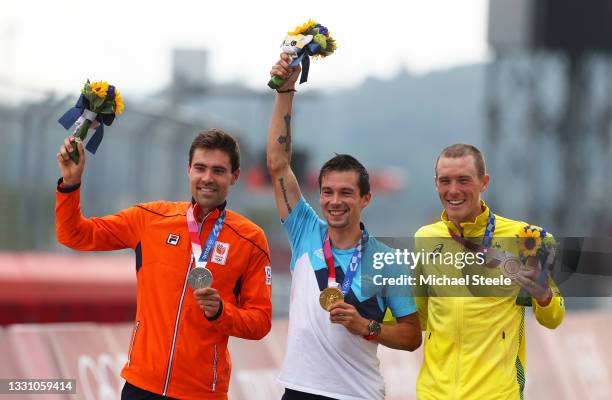 Silver medalist Tom Dumoulin of Team Netherlands, gold medalist Primoz Roglic of Team Slovenia, and bronze medalist Rohan Dennis of Team Australia,...