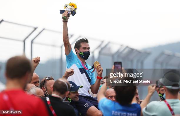 Gold medalist Primoz Roglic of Team Slovenia is lifted up by his team to celebrate their victory after the Men's Individual time trial on day five of...