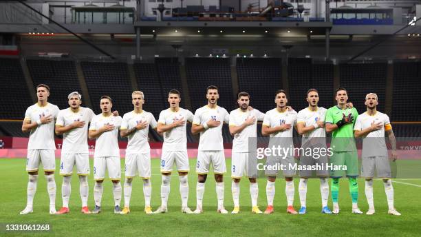 Players of Team Romania stand for the national anthem prior to the Men's First Round Group B match between Romania and New Zealand on day five of the...