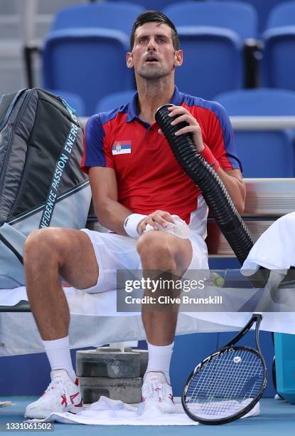 Novak Djokovic of Team Serbia attempts to keep cool between games during his Men's Singles Third Round match against Alejandro Davidovich Fokina of...