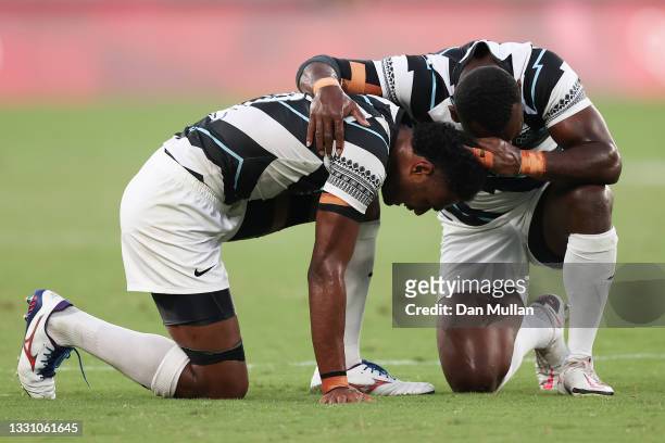 Napolioni Bolaca and Asaeli Tuivuaka of Team Fiji celebrate at the final whistle during the Rugby Sevens Men's Gold Medal match between New Zealand...