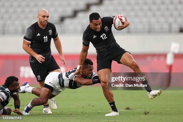 Sione Molia of Team New Zealand makes a break to score a try during the Rugby Sevens Men's Gold Medal match between New Zealand and Fiji on day five...