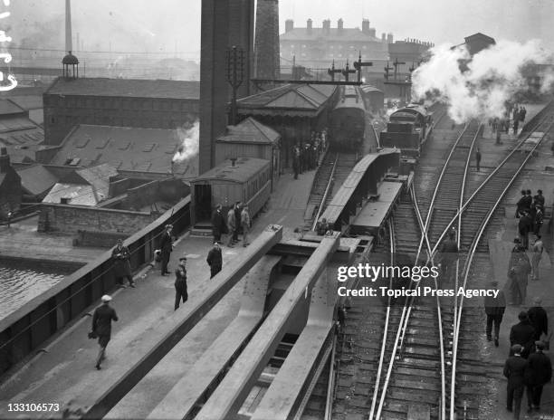 Super-sized goods train of special wagons of the London and North Eastern Railway passing through Sheffield Victoria Station, Yorkshire, 1st April...