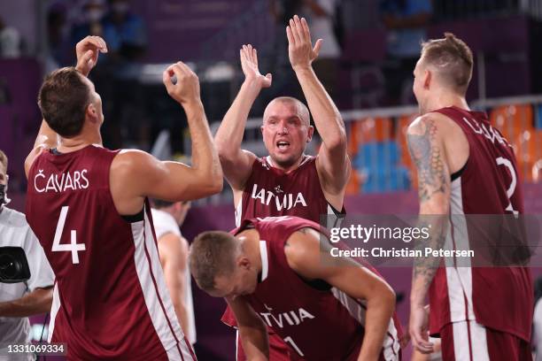 Edgars Krumins of Team Latvia celebrates victory with Agnis Cavars, Nauris Miezis and Karlis Lasmanis of Team Latvia in the 3x3 Basketball...