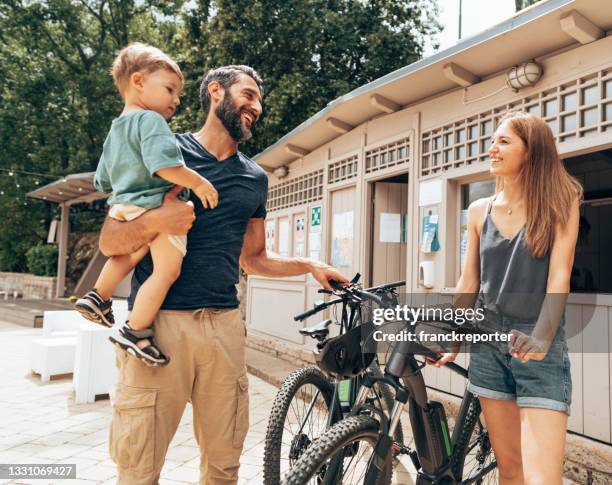 couple renting an ebike at the shop - motorbike shop stock pictures, royalty-free photos & images