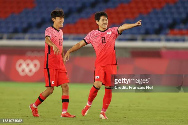 Kangin Lee of Team South Korea celebrates with teammate Jinya Kim after scoring their side's sixth goal during the Men's Group B match between...