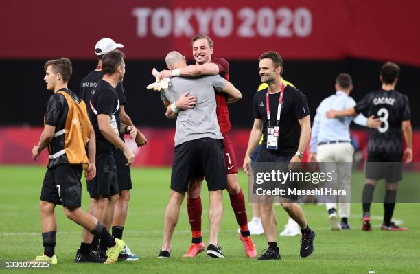 Michael Woud of Team New Zealand interacts with Danny Hay, Head Coach of Team New Zealand as they celebrate after the Men's First Round Group B match...