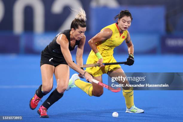 Agustina Albertarrio of Team Argentina and Bingfeng Gu of Team China battle for the ball during the Women's Preliminary Pool B match between...