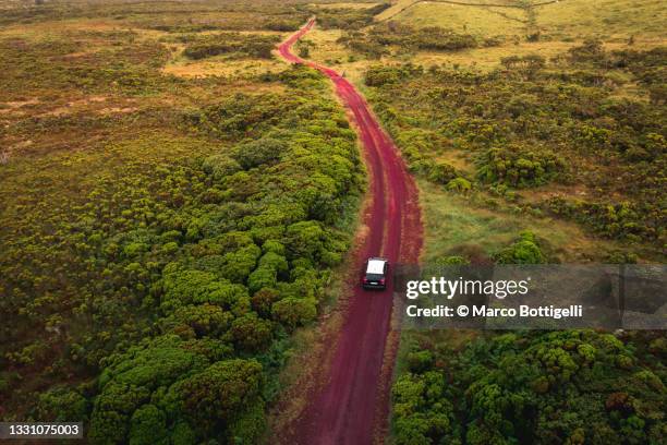 car driving on red gravel road - pico azores imagens e fotografias de stock