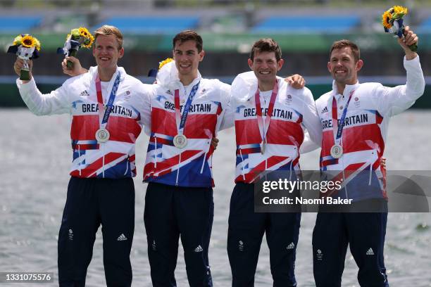 Jack Beaumont, Tom Barras, Angus Groom and Harry Leask of Team Great Britain celebrate winning the silver medal during the Men's Quadruple Sculls...