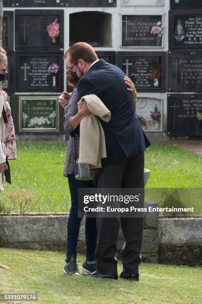 Jesus Ortiz with family members at the cemetery to say goodbye to the journalist, on 28 July 2021, in Ribadasella, Spain.