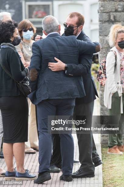 Jesus Ortiz with family members at the cemetery to say goodbye to the journalist, on 28 July 2021, in Ribadasella, Spain.