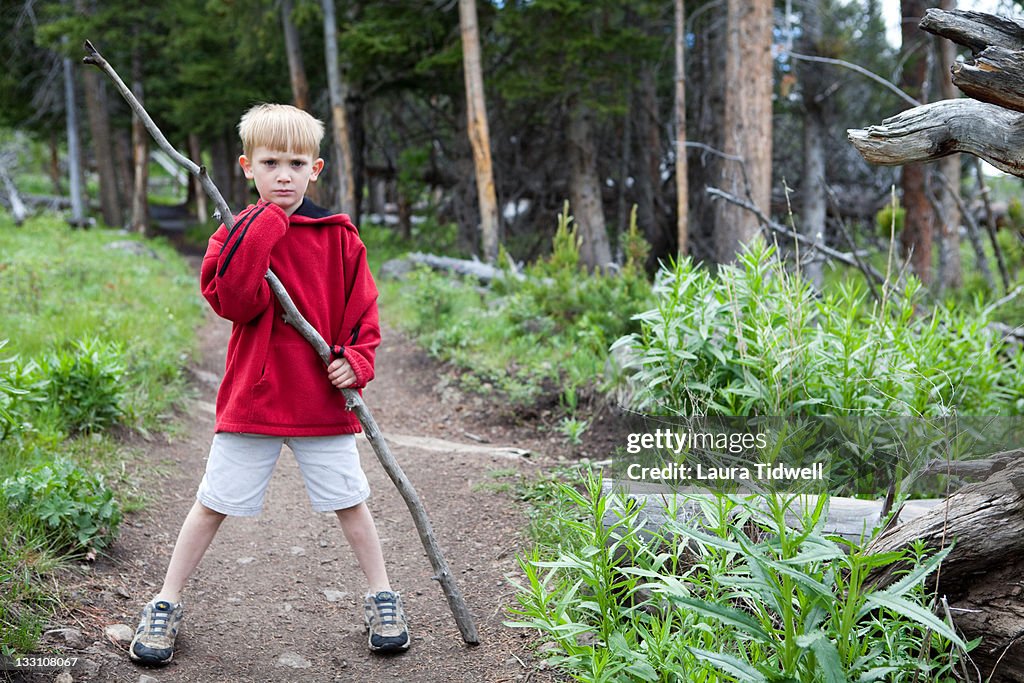 Portrait of boy holding walking stick