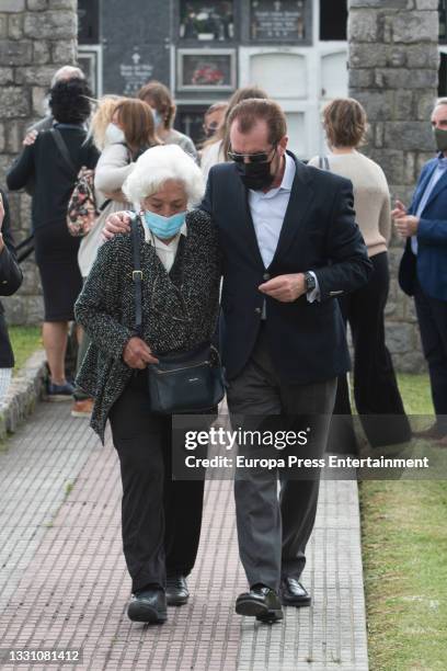 Marisol Alvarez and Jesus Ortiz leave the cemetery after saying goodbye to the journalist, Menchu Alvarez on 28 July 2021, in Ribadadasella, Spain.