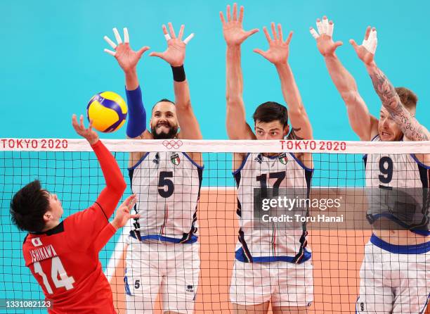 Yuki Ishikawa of Team Japan serves against Osmany Juantorena, Simone Anzani and Ivan Zaytsev of Team Italy during the Men's Preliminary Round - Pool...
