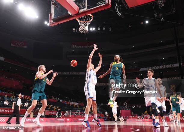 Patty Mills of Team Australia passes the ball to teammate Jock Landale as Simone Fontecchio of Team Italy defends during the second half of a Men's...