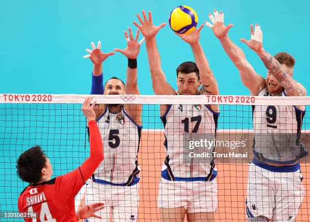 Yuki Ishikawa of Team Japan serves against Osmany Juantorena, Simone Anzani and Ivan Zaytsev of Team Italy during the Men's Preliminary Round - Pool...