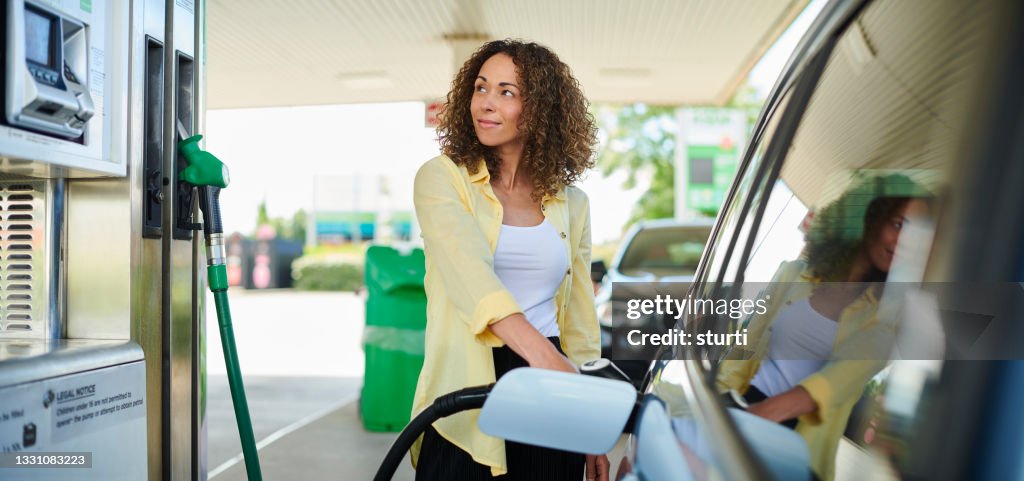 Woman filling up at the petrol pump