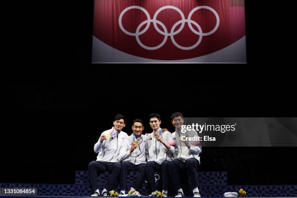 Gold medalists Sanguk Oh, Junho Kim, Bongil Gu and Junghwan Kim of Team South Korea pose with their gold medals during the Men's Sabre Team Victory...