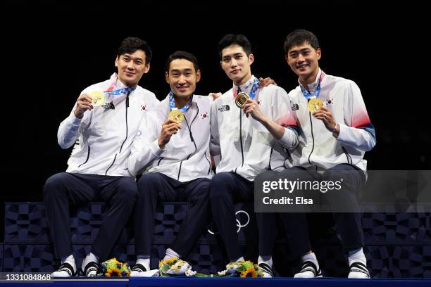 Gold medalists Sanguk Oh, Junho Kim, Bongil Gu and Junghwan Kim of Team South Korea pose with their gold medals during the Men's Sabre Team Victory...