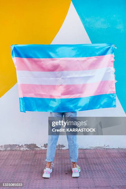 person holding a transgender flag - transgender foto e immagini stock