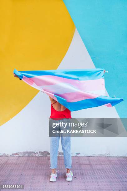 person holding a transgender flag - transgender bildbanksfoton och bilder