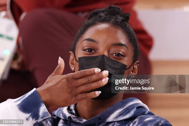 Simone Biles of Team United States blows a kiss whilst watching the Men's All-Around Final on day five of the Tokyo 2020 Olympic Games at Ariake...