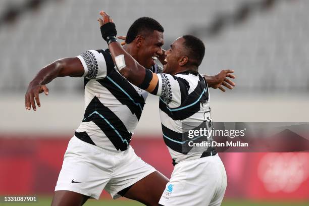 Waisea Nacuqu of Team Fiji celebrates victory with Kalione Nasoko of Team Fiji during the Rugby Sevens Men's Gold Medal match between New Zealand and...