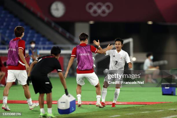 Takefusa Kubo of Team Japan celebrates after scoring their side's first goal during the Men's Group A match between France and Japan on day five of...
