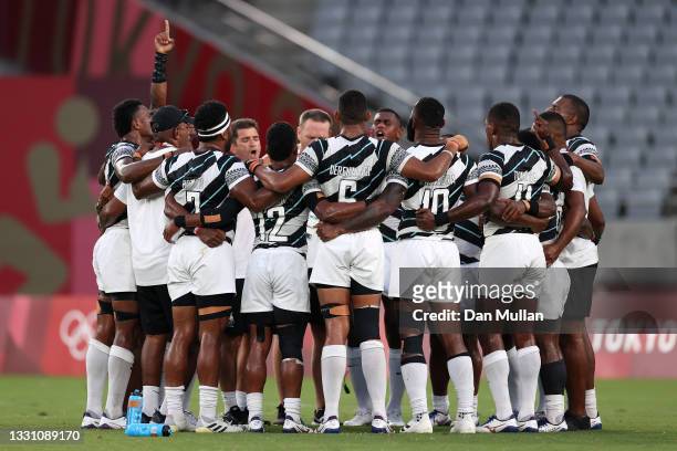 Team Fiji sing a song in a huddle following their victory in the Rugby Sevens Men's Gold Medal match between New Zealand and Fiji on day five of the...