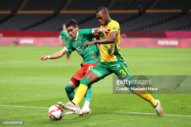Uriel Antuna of Team Mexico is challenged by Katlego Mohamme of Team South Africa during the Men's First Round Group A match between South Africa and...