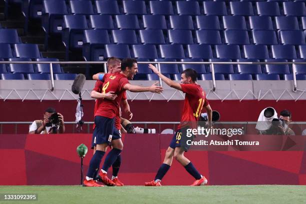 Mikel Merino of Team Spain celebrates with Pedri Gonzalez after scoring their side's first goal during the Men's First Round Group C match between...