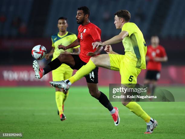 Ahmed Rayan of Team Egypt controls the ball whilst under pressure from Harry Souttar of Team Australia during the Men's Group C match between...