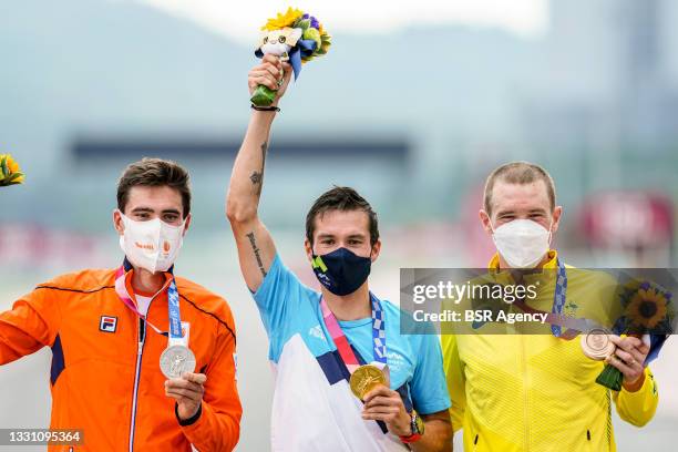 Tom Dumoulin of the Netherlands with his silver medal, Primoz Roglic of Slovenia with his gold medal and Rohan Dennis of Australia with his bronze...