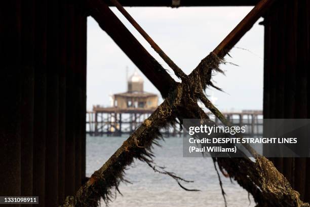 remnants of the old pier from below the new pier at herne bay in kent - herne bay foto e immagini stock