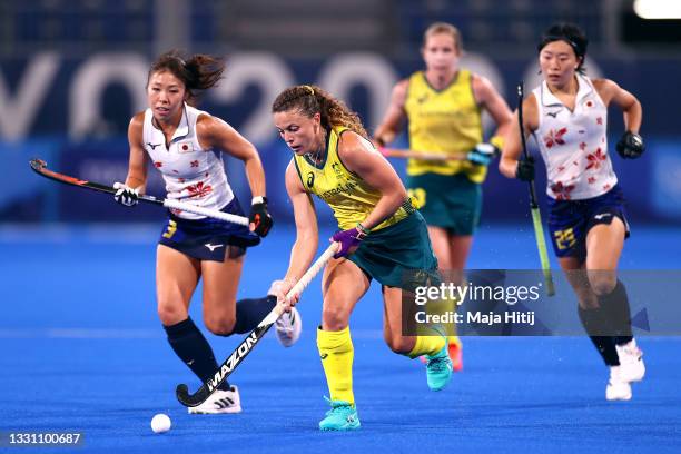 Ambrosia Malone of Team Australia runs with the ball whilst under pressure from Kimika Hoshi of Team Japan during the Women's Preliminary Pool B...