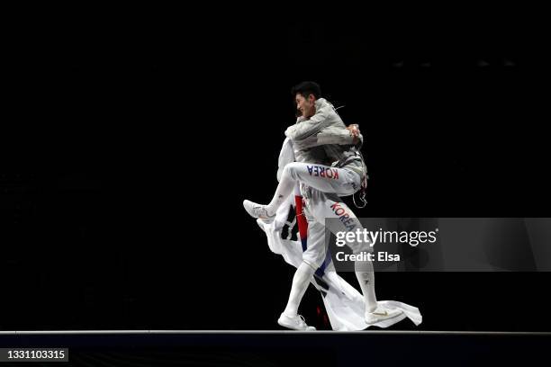 Team South Korea celebrate after defeating Team Italy during the Men's Sabre Team Gold Medal Match on day five of the Tokyo 2020 Olympic Games at...