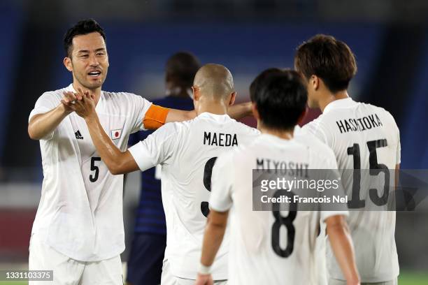 Maya Yoshida of Team Japan congratulates Daizen Maeda after he scored the Team Japan fourth goal during the Men's Group A match between France and...