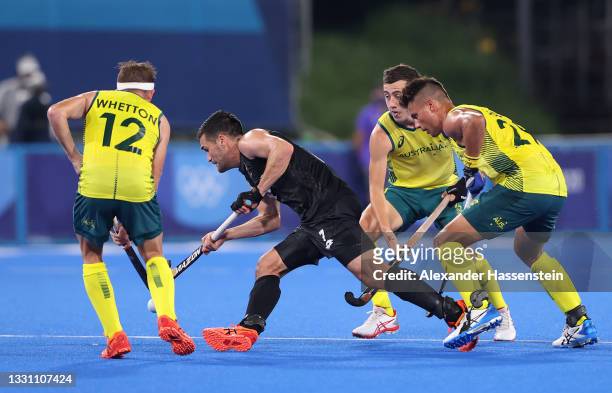 Nick Ross of Team New Zealand is pressured by Jacob Thomas Whetton and Tim Brand of Team Australia during the Men's Preliminary Pool A match between...
