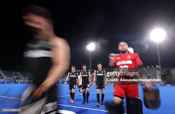 Sam Lane, Nick Wilson and Jake Smith of Team New Zealand leave the pitch following the Men's Preliminary Pool A match between Australia and New...