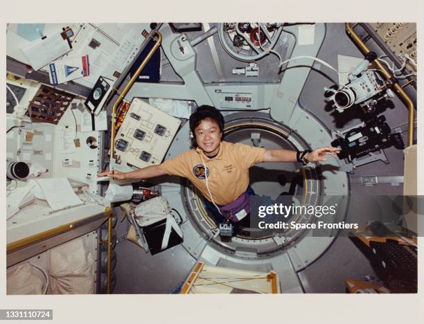 Japanese JAXA astronaut Chiaki Mukai is ready to begin one of her busy twelve-hour shifts as she enters the International Microgravity Laboratory 2...