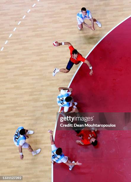 Christian O'Sullivan of Team Norway shoots for goal as Nicolas Bonanno of Team Argentina and Sander Sagosen of Team Norway collide during the Men's...