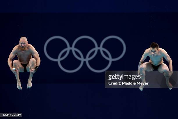 Evgenii Kuznetsov and Nikita Shleikher of Team Russian Olympic Committee compete during the Men's Synchronised 3m Springboard final on day five of...